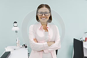 Portrait of mature woman owner of beauty salon for nail care and hands with arms crossed, background beauty salon