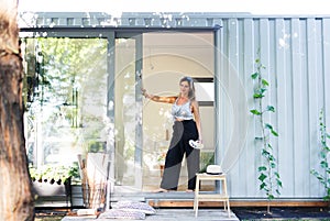 Portrait of mature woman with pallete painting in container house.