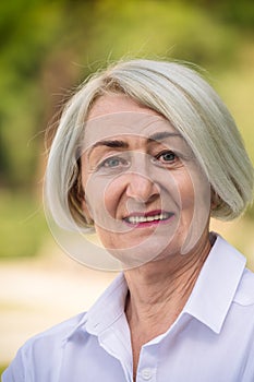 Portrait mature woman while resting at the park