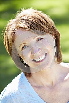 Portrait Of Mature Woman Sitting In Field