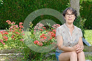 Portrait of a mature woman sitting in garden
