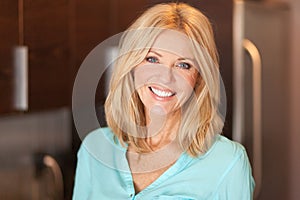 Portrait of a mature woman smiling at the camera. She is confident and proud