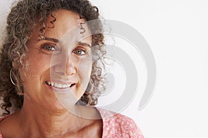 Portrait Of Mature Woman Standing Against Wall