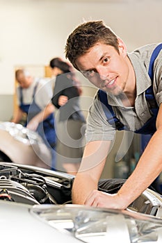 Portrait of mechanic repairing car