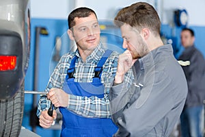 portrait mechanic teaching apprentice