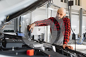 Portrait of a mechanic at work in his garage