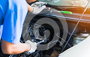 Portrait of Mechanical repairing engine car in workshop