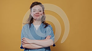 Portrait of medic posing confident with arms crossed wearing hospital uniform with copy space