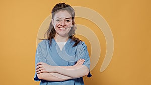 Portrait of medic posing confident with arms crossed wearing hospital uniform with copy space