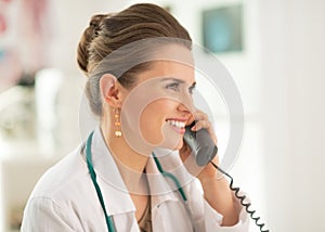 Portrait of medical doctor woman talking phone