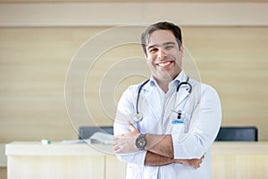 Portrait medical male doctor wear white coat hanging stethoscope smiling arms crossed profession standing in hospital. business