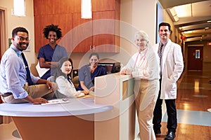 Portrait Of Medical Staff At Nurse's Station In Hospital