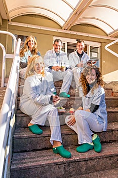 Portrait of medical staff sitting outdoors during lunch break