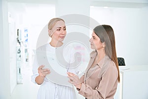 Portrait of medical worker talking with visitor
