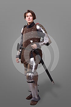 Portrait of a medieval female knight in armour over grey background