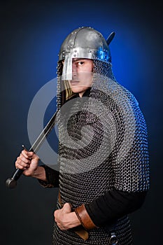 Portrait of a medieval warrior of the late Viking era and the beginning of the Crusades. Knight in chain mail and helmet