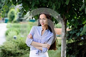 Portrait of a mediterranean, smiling woman with long, black hair