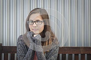 Portrait of Melancholy Teen Bookworm Girl Wearing Glasses