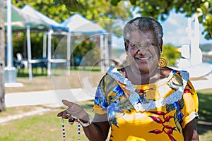 Portrait of a melanesian - australian mature woman smiling, outdoors. photo