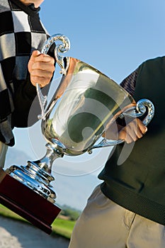 Portrait of Men Holding Golf Trophy