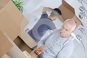 portrait men packing their boxes