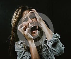 Portrait, mental health and horror with woman screaming in studio on black background for reaction to fear. Face