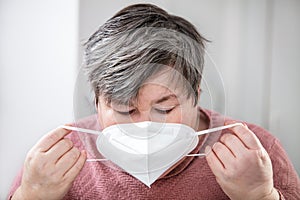 portrait of a mentally disabled or handicapped woman  wearing a ffp2 mask photo