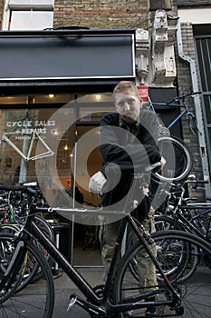 Portrait of mid adult man standing outside cycle shop