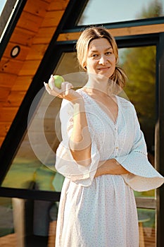 Portrait of mid adult woman with apple