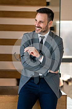 Portrait of mid age adult business man standing in modern office. Successful entrepreneur in formal