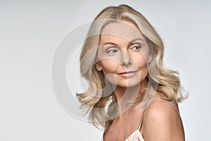 Portrait of mid age woman advertising face and body care on white background.