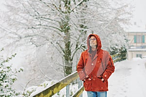 Portrait of middle age man, 55 - 60 years old, enjoying nice cold day, wearing red orange winter jacket