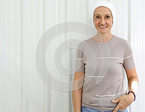 Portrait of middle age woman with clothe cover abound head to hide hair loss from chemotherapy in breast cancer cure process,