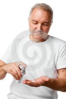 Portrait of middle aged, 45s man using skin care cream, lotion against white studio background.