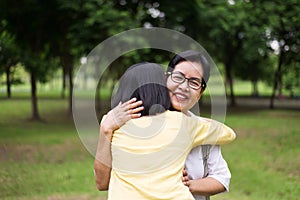 Portrait of middle aged asian woman with daughter standing and hugging together outdoor,Happy and smiling,Positive thinking,Take c