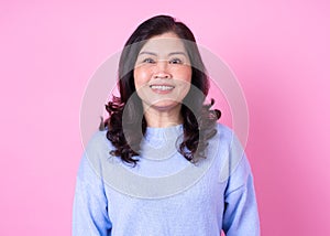 Portrait of middle aged Asian woman on pink background