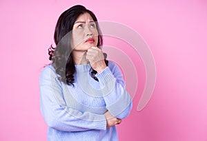 Portrait of middle aged Asian woman on pink background