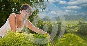 Portrait of a middle-aged brunette woman with eyeglasses, outdoor