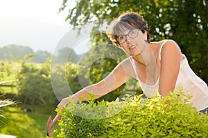 Portrait of a middle-aged brunette woman with eyeglasses, outdoor