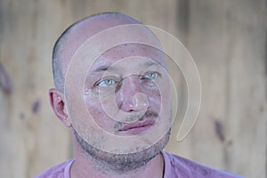 Portrait of middle-aged caucasian bald man, close up