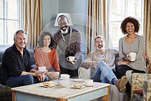 Portrait Of Middle Aged Friends Meeting In Coffee Shop