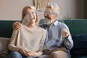 Portrait of middle aged laughing man and woman at home