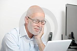 Portrait of a middle-aged man with a digital tablet