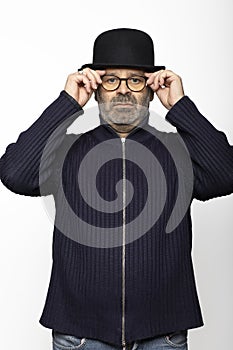 Portrait middle aged man with glasses, bowler hat and round glasses