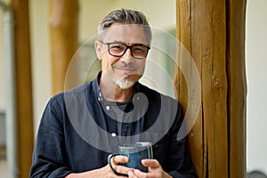 Portrait of middle aged man at home drinking coffee outdoor