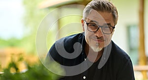 Portrait of middle aged man at home relaxing in garden