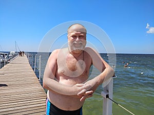 Portrait of a middle aged man standing at the pier