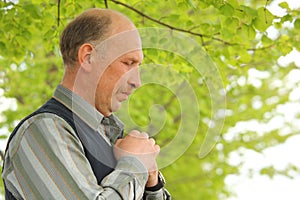 Portrait of middle-aged praying man