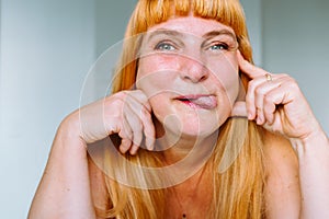 Portrait middle-aged red-haired woman