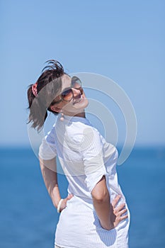 Portrait of middle aged woman against sea